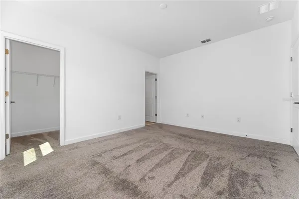a view of a house with a big yard and potted plants