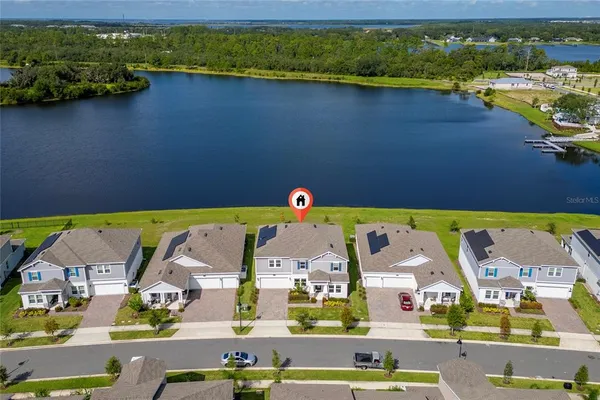 an aerial view of residential houses with outdoor space and swimming pool