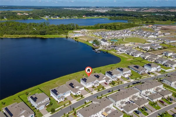 an aerial view of a house with a lake view