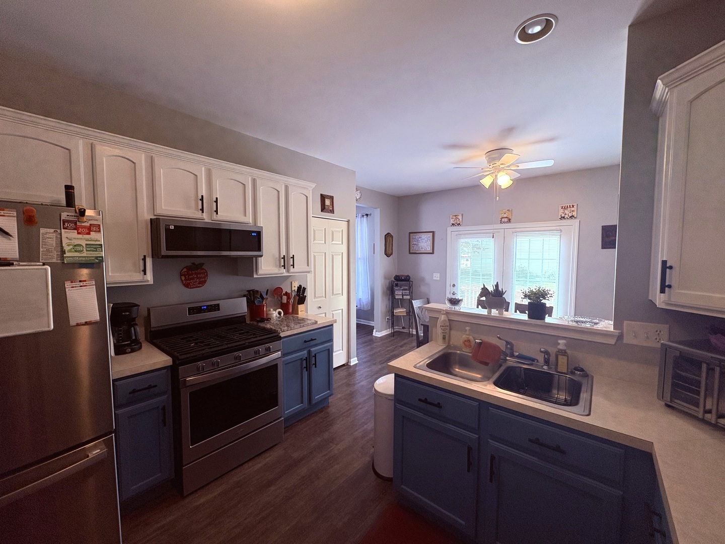 1461 Waterside Drive DeKalb, IL 60115 - Photo 16 of 29 a kitchen with stainless steel appliances a stove a sink a microwave and cabinets