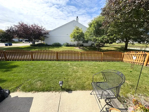 a view of a chair and table in the backyard