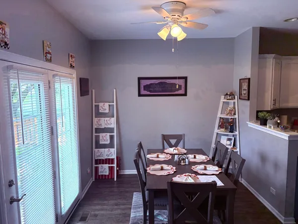 a view of a dining room with furniture wooden floor and chandelier