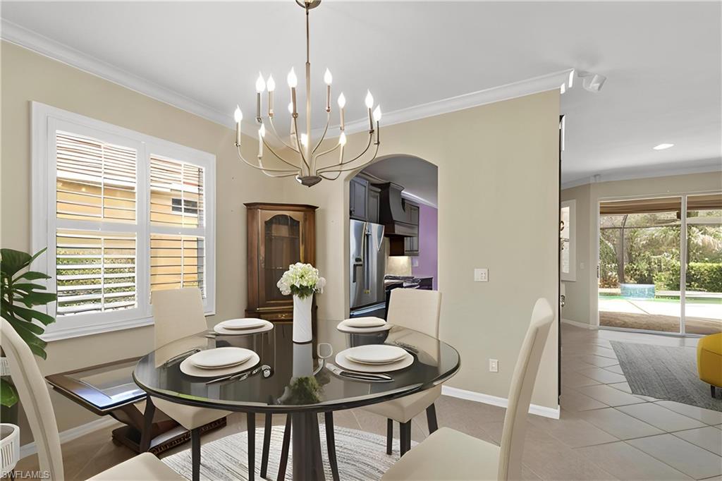 20451 Rookery Drive Estero, FL 33928 - Photo 12 of 44 a view of a dining room with furniture wooden floor and chandelier