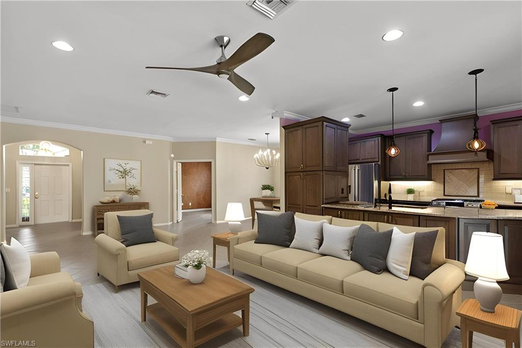 20451 Rookery Drive Estero, FL 33928 - Photo 14 of 44 a living room with furniture kitchen view and a chandelier