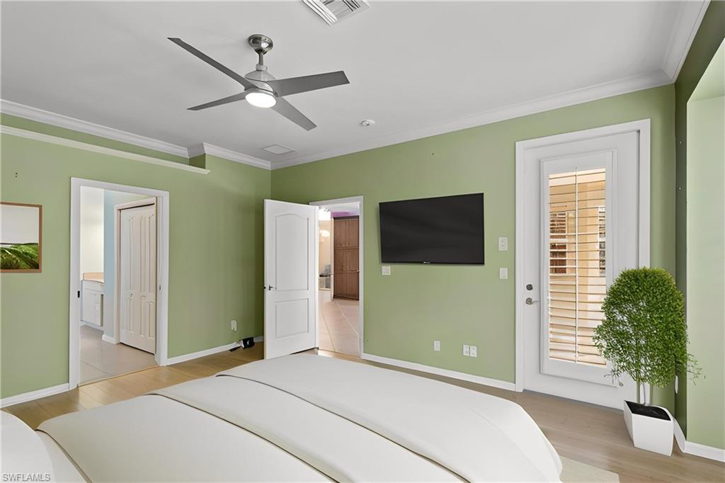 20451 Rookery Drive Estero, FL 33928 - Photo 21 of 44 a bedroom with a bed and a television