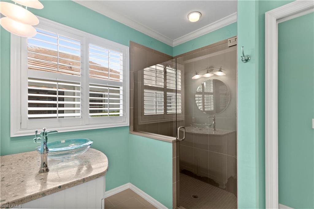 20451 Rookery Drive Estero, FL 33928 - Photo 24 of 44 a bathroom with a granite countertop sink and a large mirror