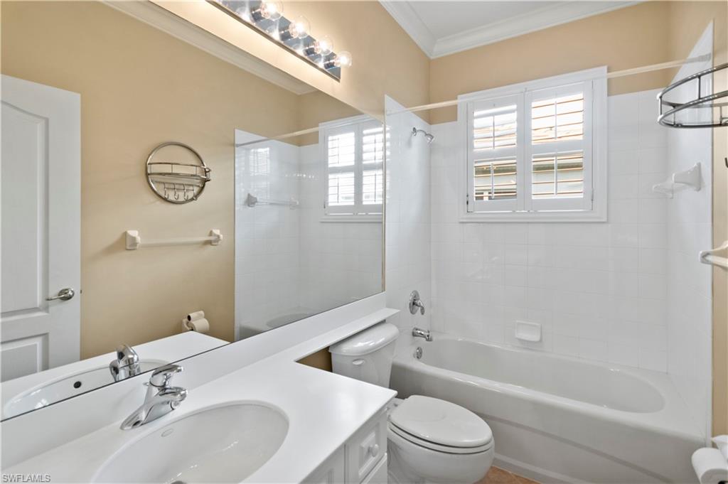 20451 Rookery Drive Estero, FL 33928 - Photo 28 of 44 a bathroom with a toilet sink vanity tub and shower