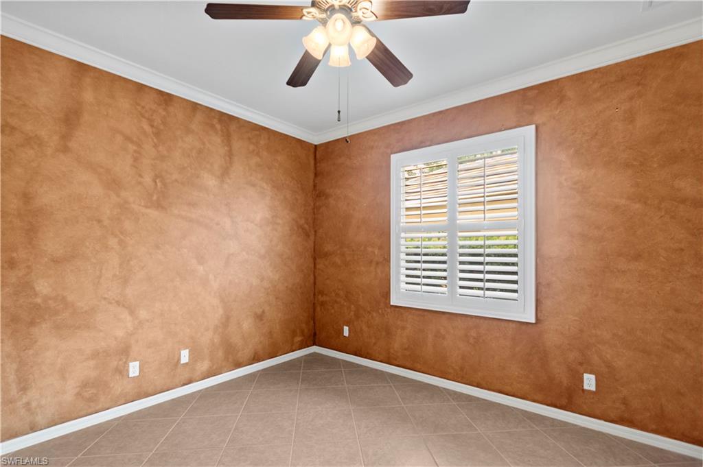 20451 Rookery Drive Estero, FL 33928 - Photo 32 of 44 a view of an empty room with window and chandelier fan
