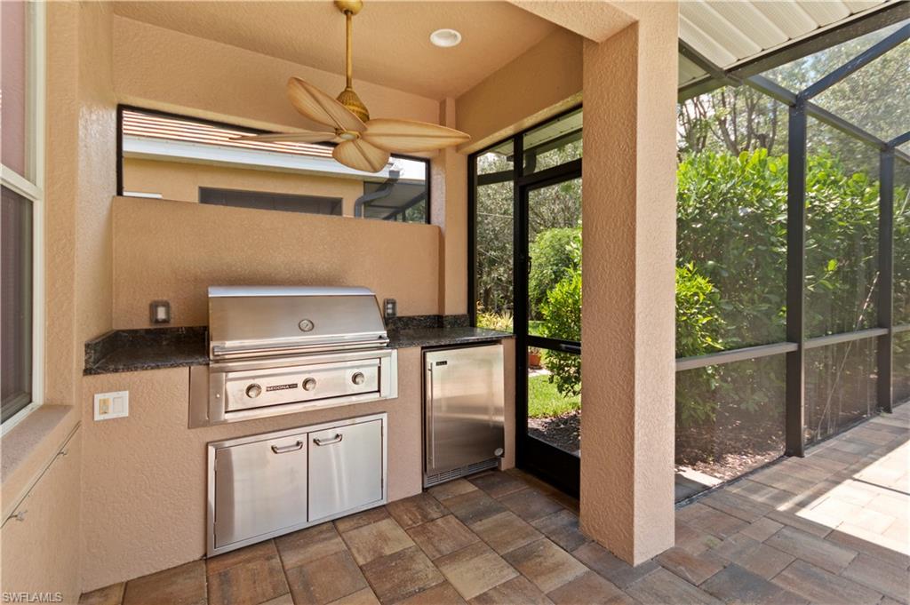 20451 Rookery Drive Estero, FL 33928 - Photo 35 of 44 a kitchen with a stove and a refrigerator