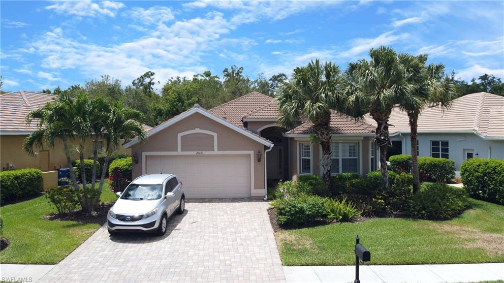20451 Rookery Drive Estero, FL 33928 - Photo 40 of 44 a front view of a house with a garden