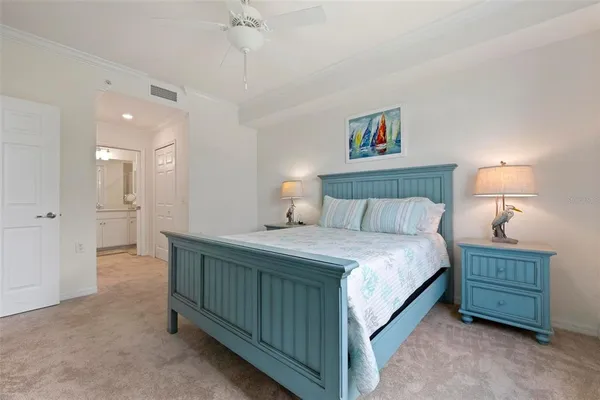 a bedroom with a bed a dresser and night lamp