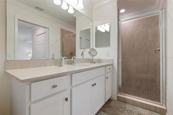 a bathroom with a shower sink and mirror