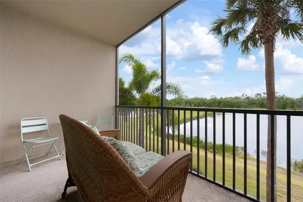a balcony with table and chairs