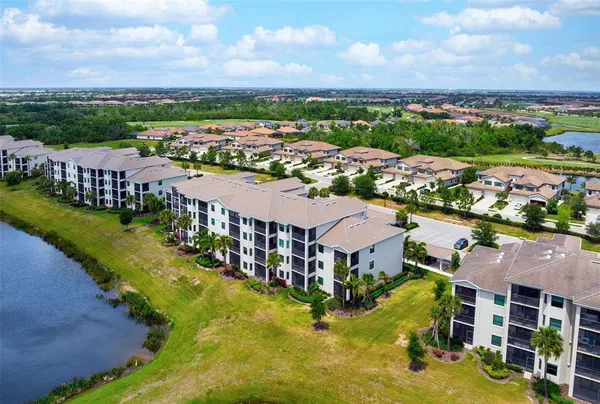 an aerial view of residential houses with outdoor space and river