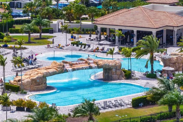 an outdoor space with swimming pool and furniture