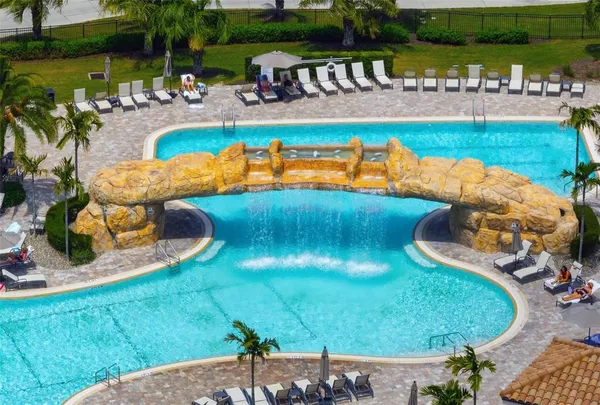 a view of a swimming pool with a yard and outdoor seating