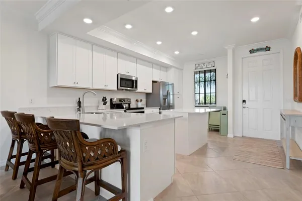 a kitchen with cabinets and chairs