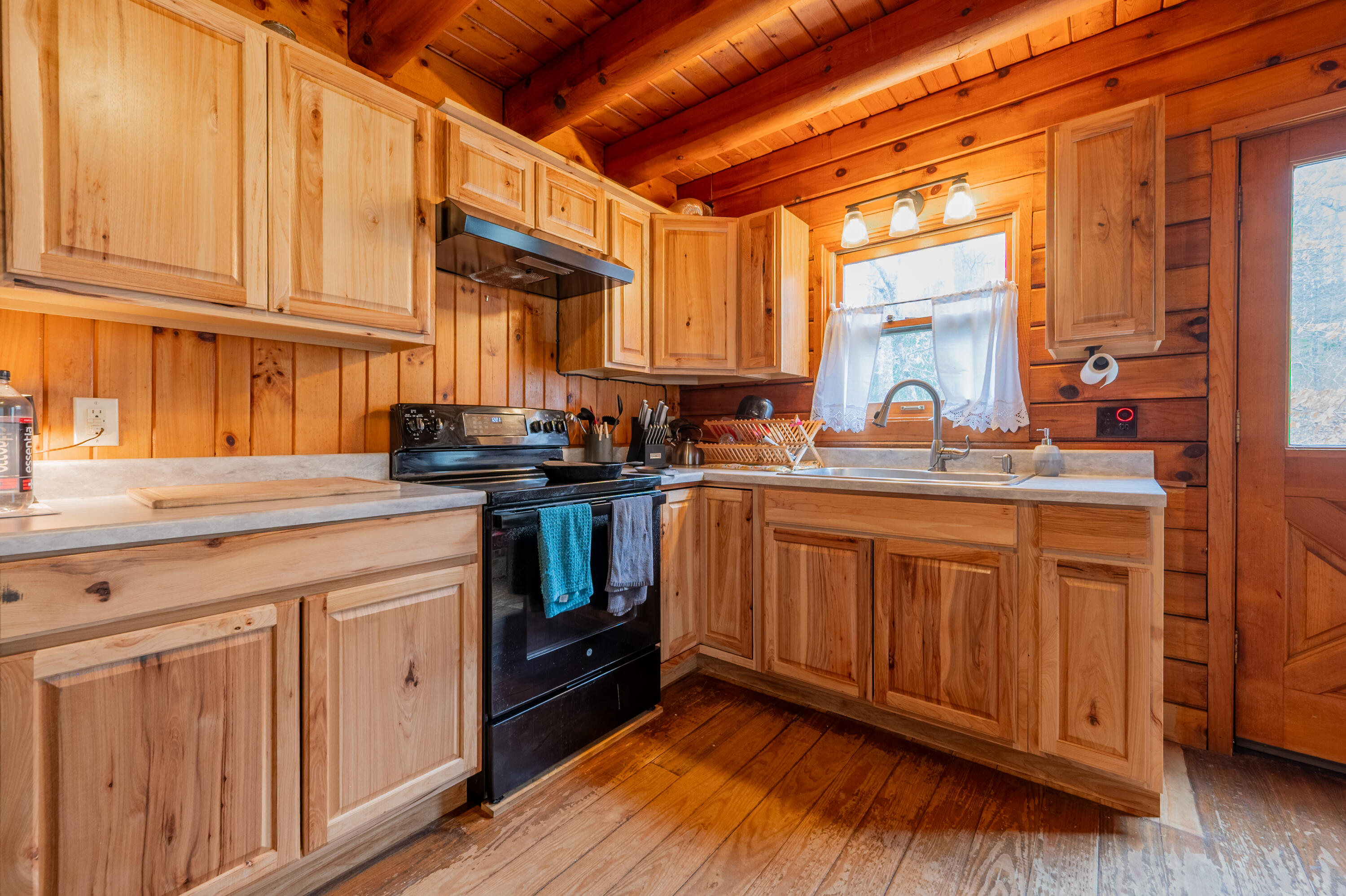 183 Pine Mountain Road Northeast Floyd, VA 24091 - Photo 16 of 54 a kitchen with stainless steel appliances granite countertop a sink a stove and wooden cabinets