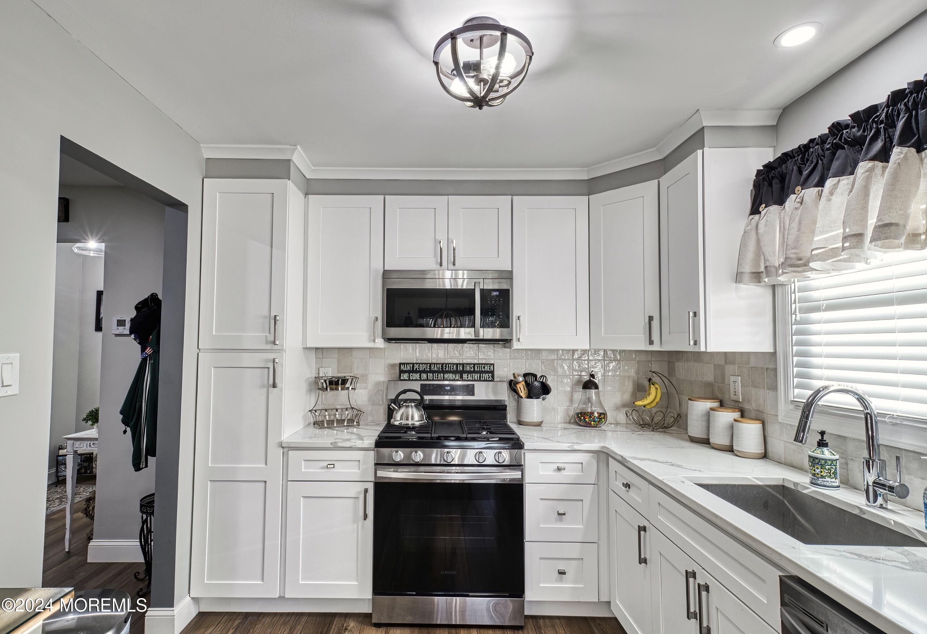 6 Masters Road Brick, NJ 08724 - Photo 13 of 38 a kitchen with cabinets stainless steel appliances and a window