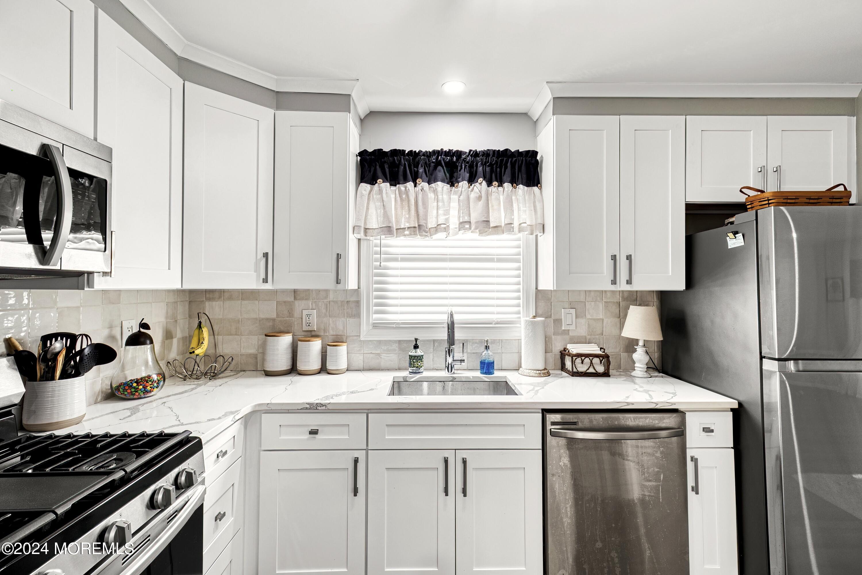 6 Masters Road Brick, NJ 08724 - Photo 14 of 38 a kitchen with a sink stove and refrigerator