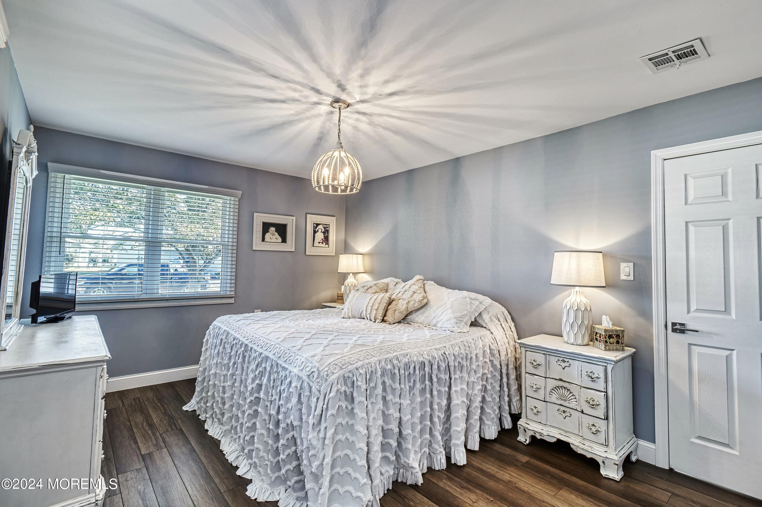 6 Masters Road Brick, NJ 08724 - Photo 17 of 38 a bedroom with a bed and a chandelier