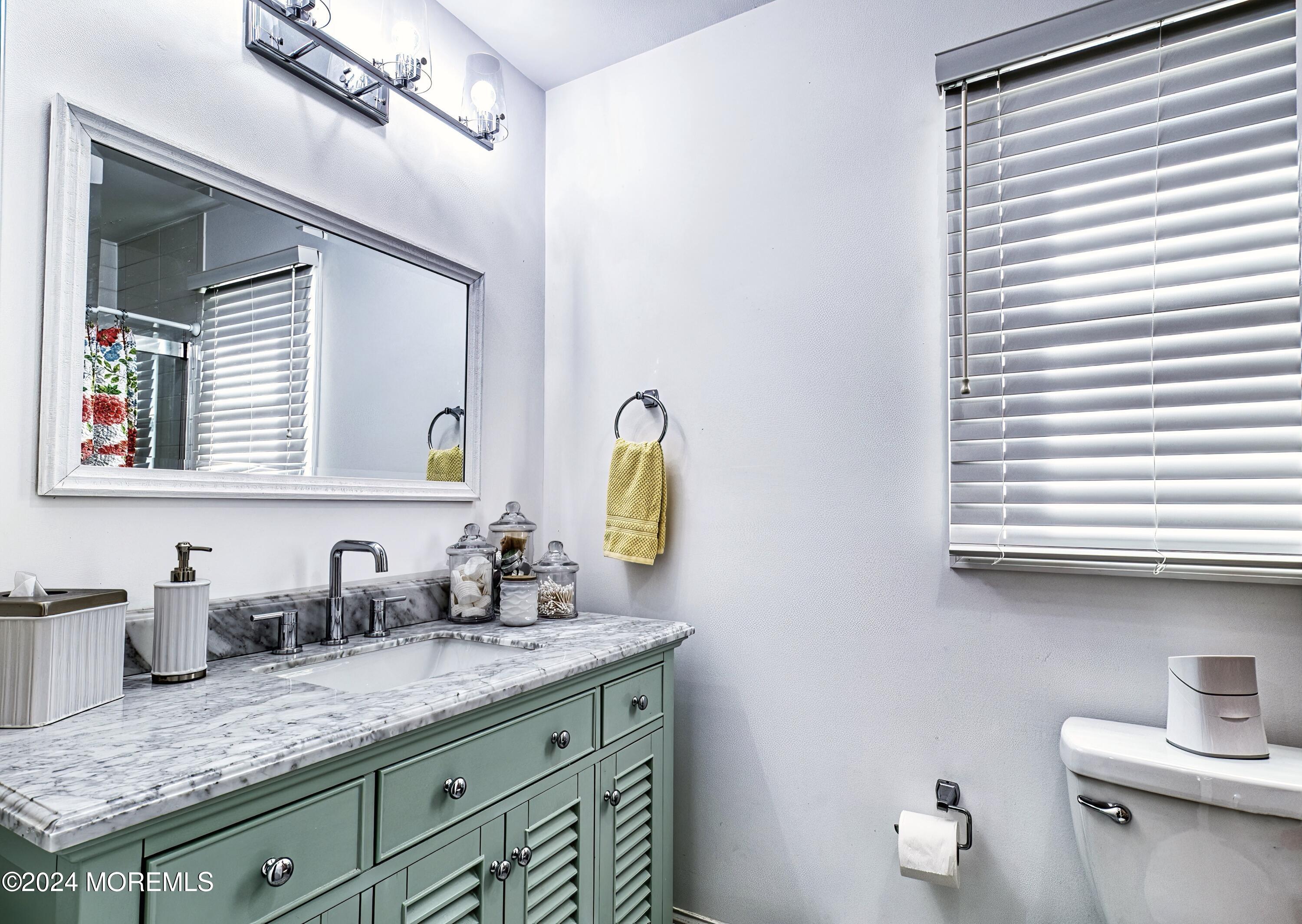 6 Masters Road Brick, NJ 08724 - Photo 20 of 38 a bathroom with a granite countertop sink and a mirror