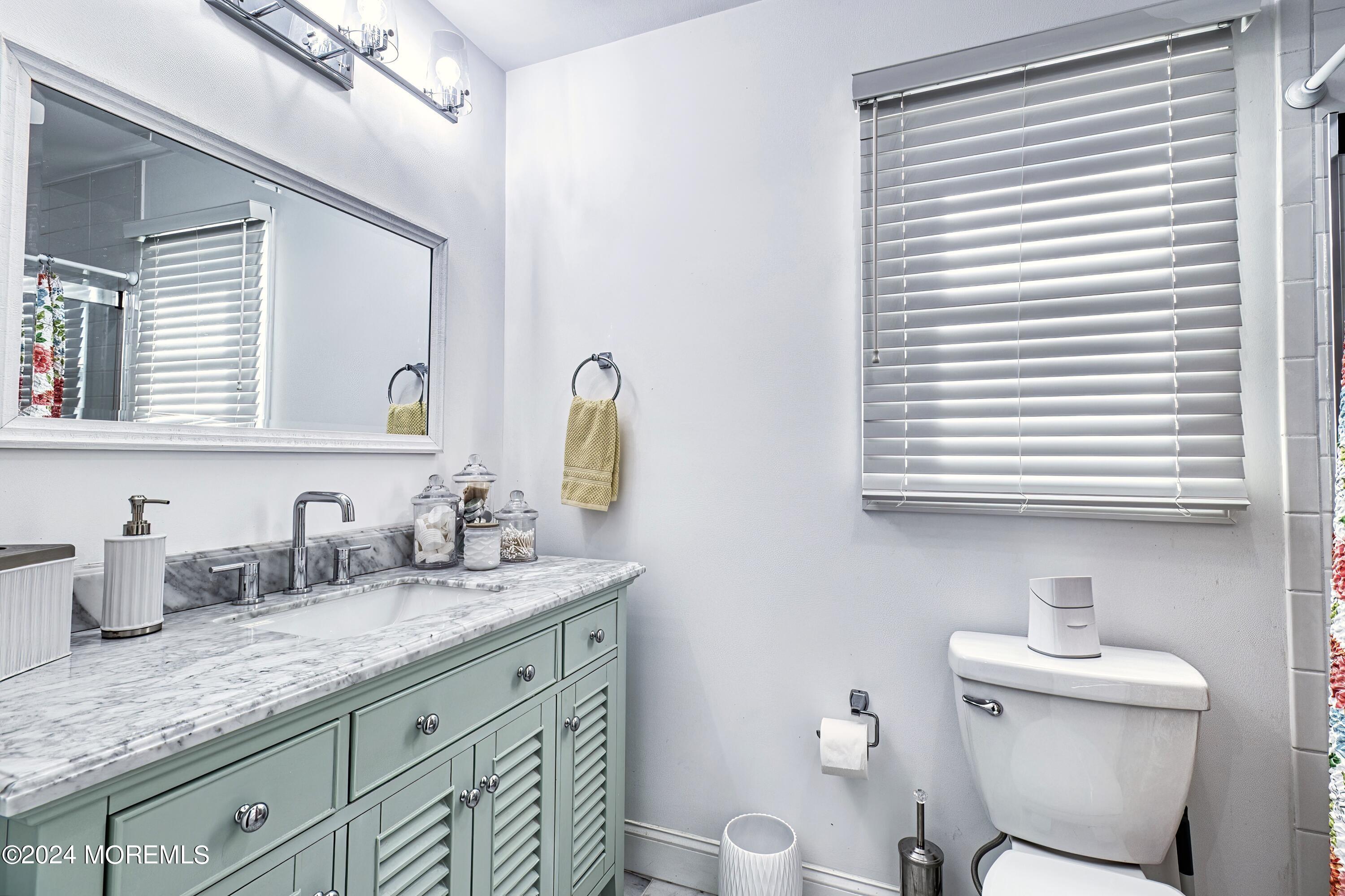 6 Masters Road Brick, NJ 08724 - Photo 21 of 38 a bathroom with a granite countertop toilet sink and mirror