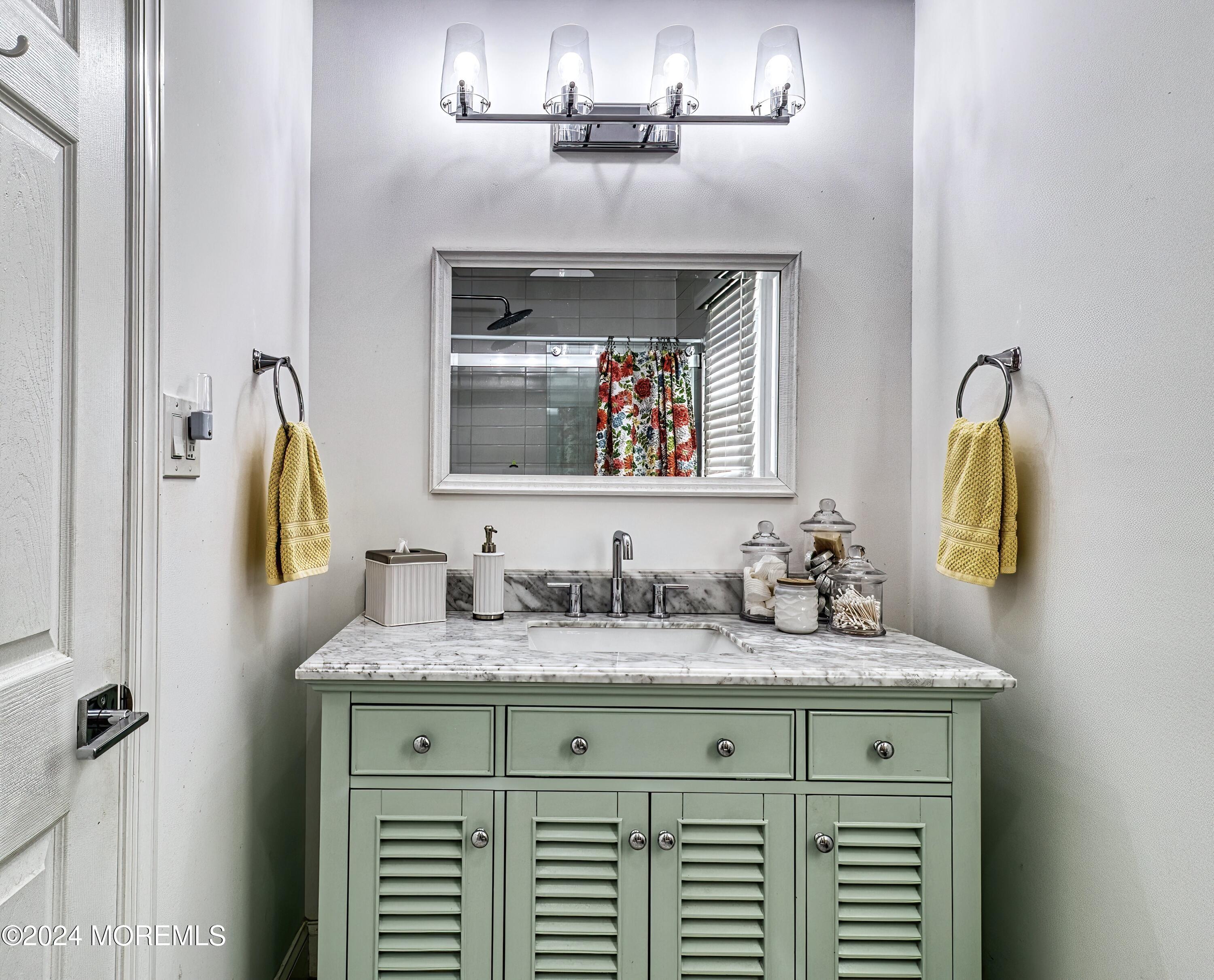 6 Masters Road Brick, NJ 08724 - Photo 23 of 38 a bathroom with a sink and a mirror