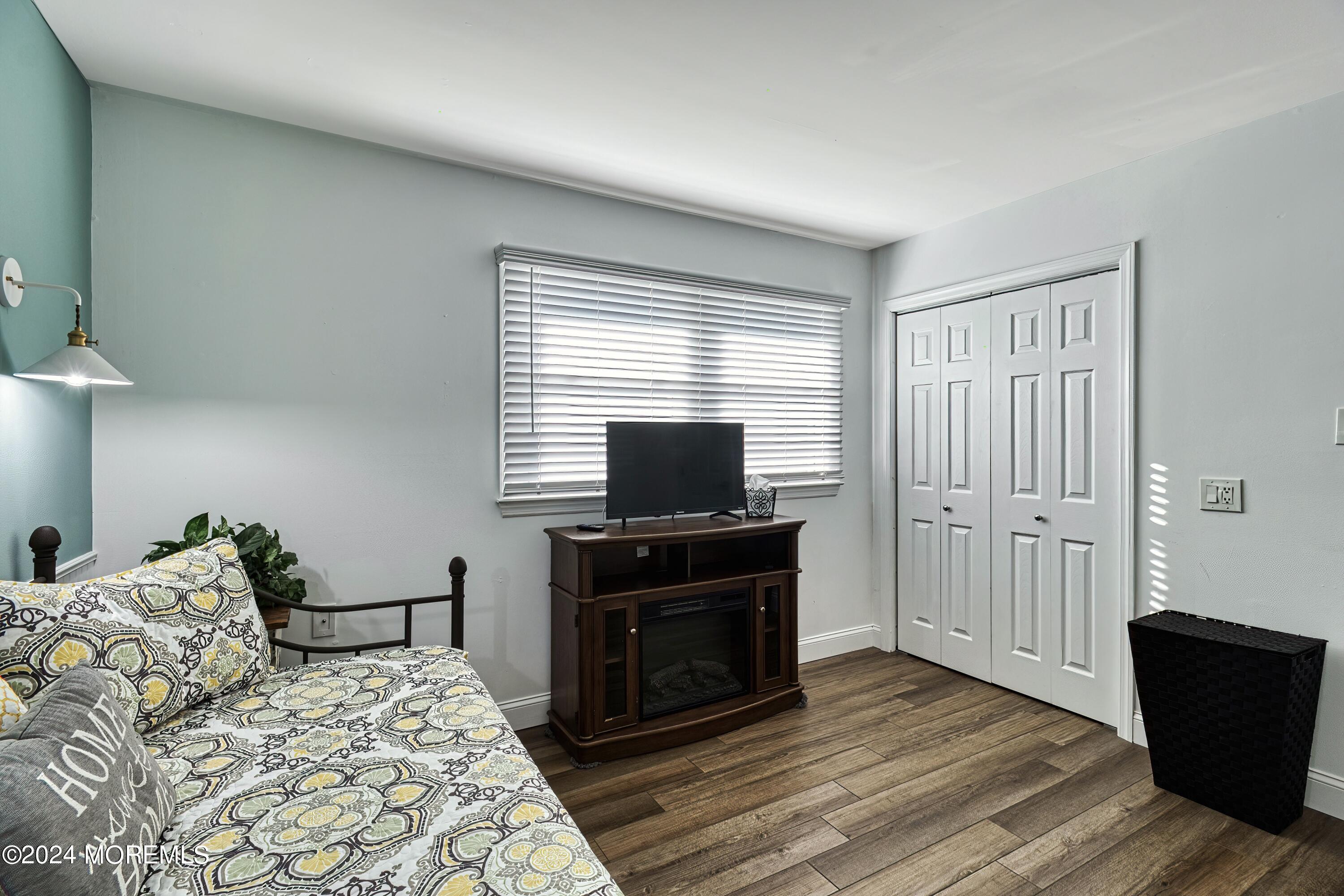6 Masters Road Brick, NJ 08724 - Photo 36 of 38 a bedroom with a bed and a fireplace