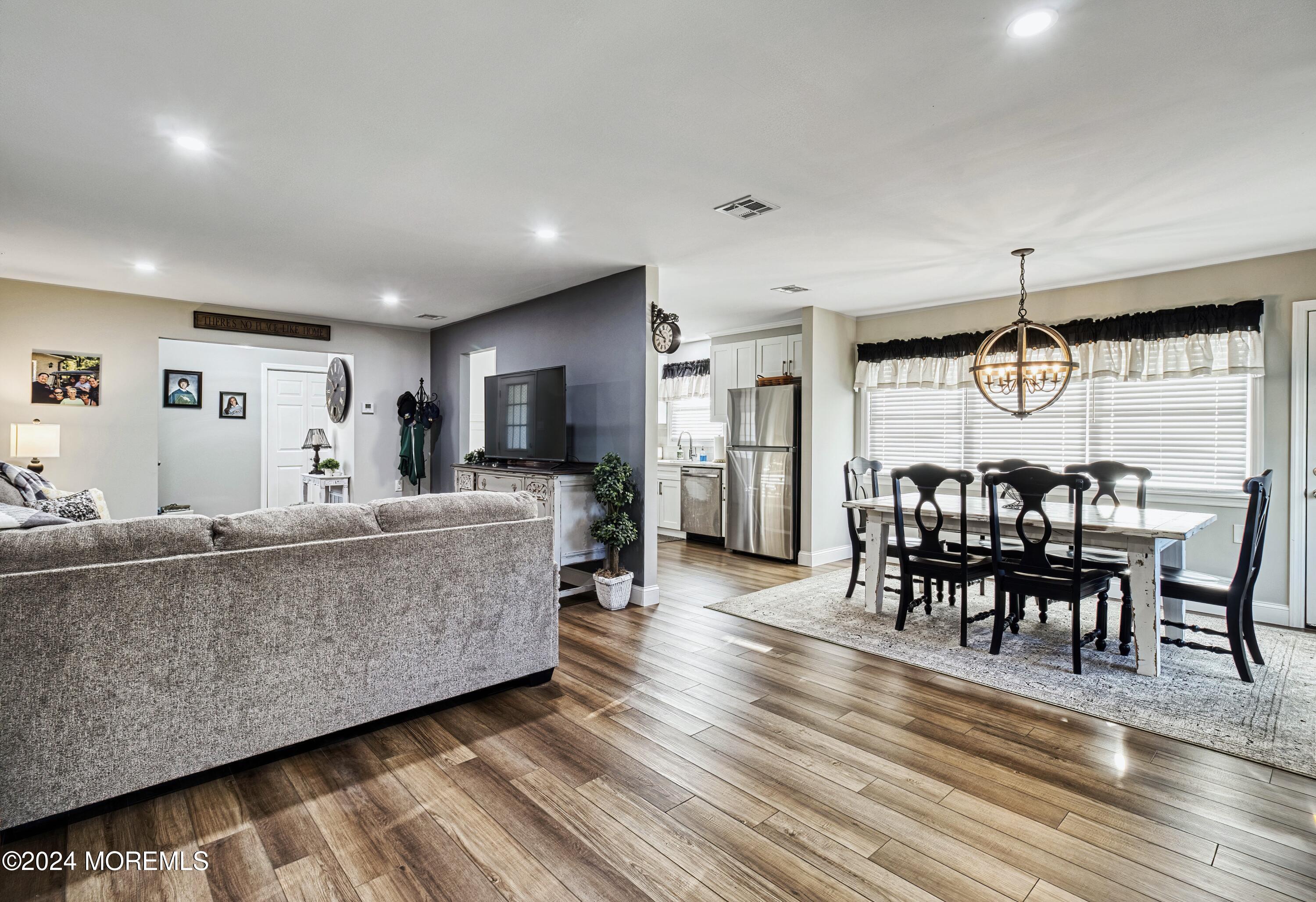 6 Masters Road Brick, NJ 08724 - Photo 9 of 38 a living room with furniture a dining table and wooden floor