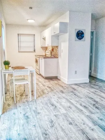 a view of kitchen with furniture and wooden floor