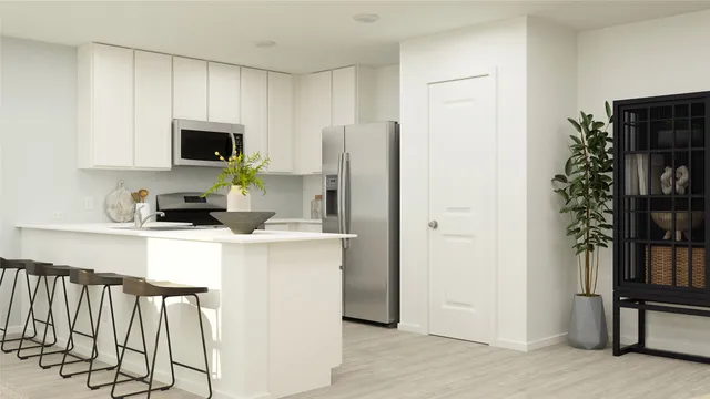 a kitchen with stainless steel appliances a refrigerator sink and microwave