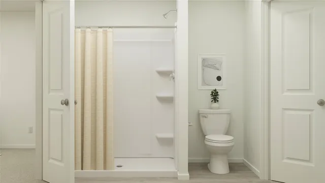 a white toilet sitting next to a bathroom sink