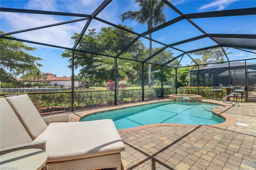 9434 Piacere Way Naples, FL 34113 - Photo 12 of 32 View of pool featuring a patio, a pool with connected hot tub, and a lanai