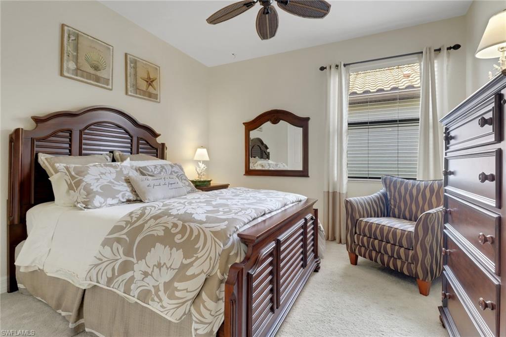 9434 Piacere Way Naples, FL 34113 - Photo 19 of 32 Bedroom with light colored carpet and a ceiling fan