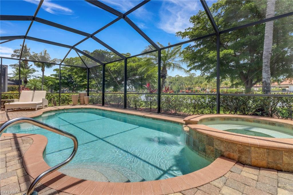9434 Piacere Way Naples, FL 34113 - Photo 3 of 32 View of swimming pool with a pool with connected hot tub and glass enclosure