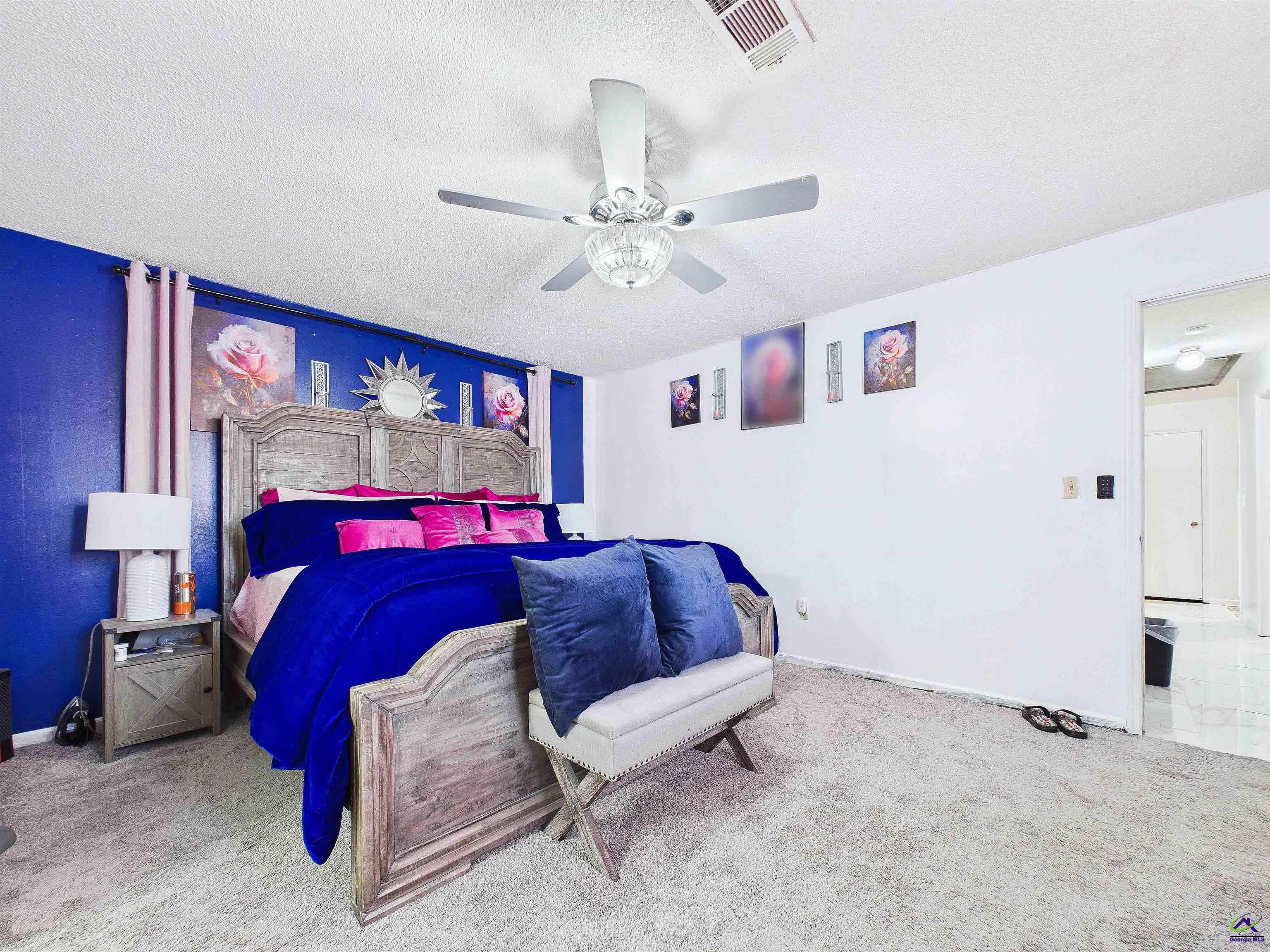 400 Feagin Mill Road Warner Robins, GA 31005 - Photo 36 of 53 a bedroom with a bed and a chandelier