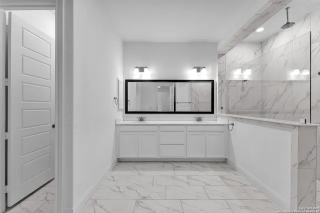 a bathroom with a double vanity sink and a mirror