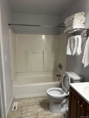 a bathroom with a toilet and a bathtub
