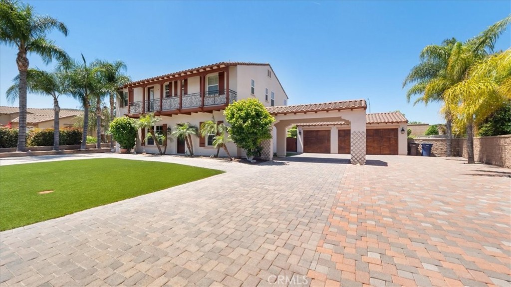 5969 Vía Las Nubes Riverside, CA 92506 - Photo 1 of 1 a front view of a house with a yard and palm trees