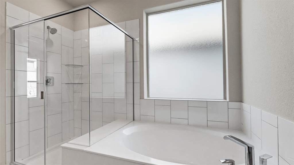 11305 Treehouse Trail Justin, TX 76247 - Photo 14 of 39 a bathroom with a bathtub and a shower