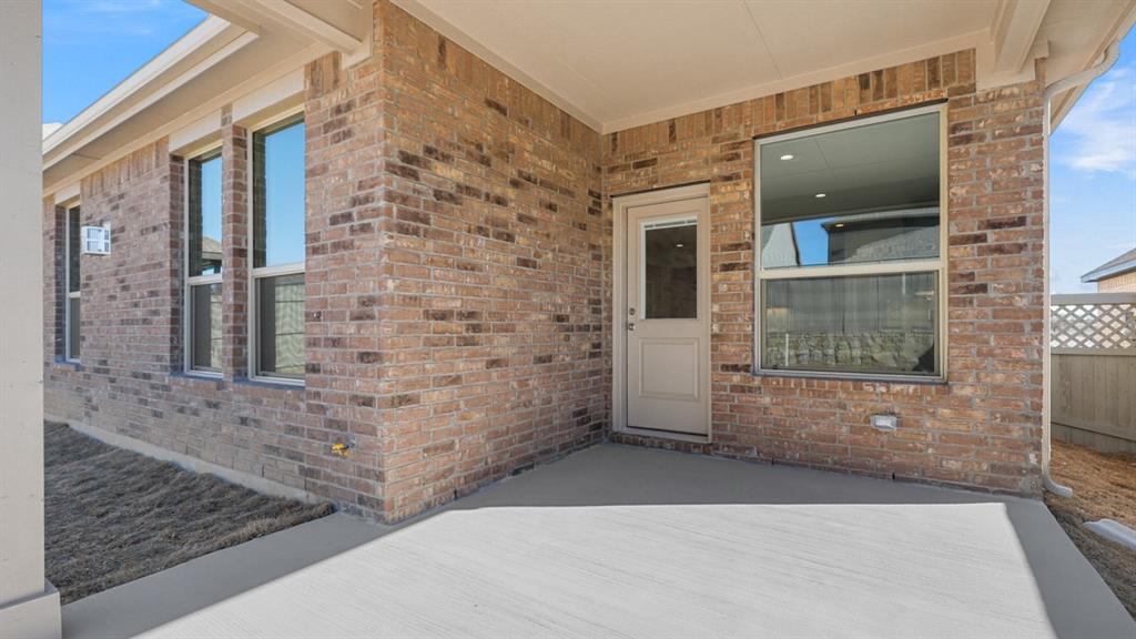 11305 Treehouse Trail Justin, TX 76247 - Photo 38 of 39 a view of a brick house with a street