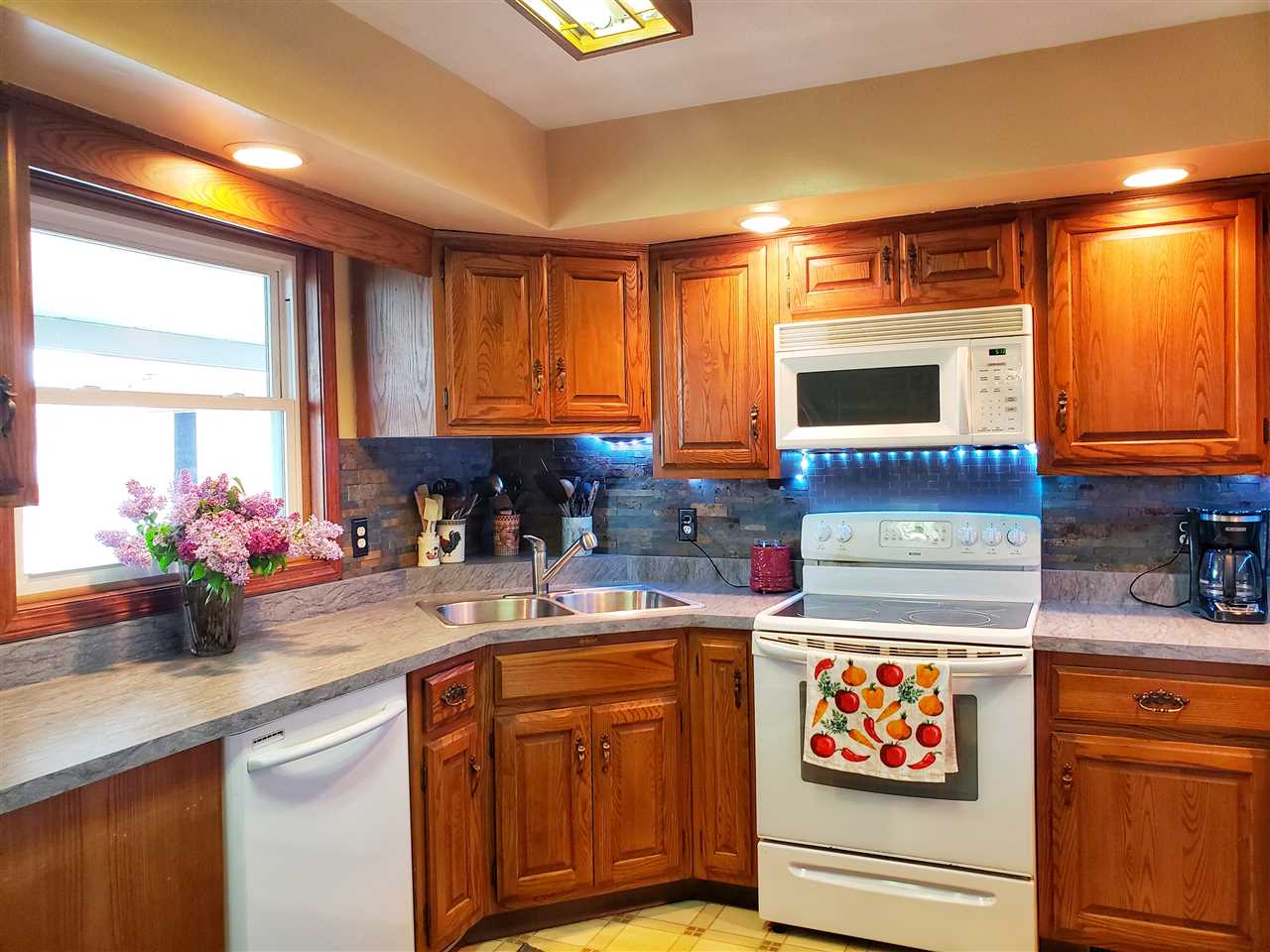 4365 East Brick Road Oregon, IL 61061 - Photo 9 of 25 a kitchen with stainless steel appliances granite countertop a stove a sink and a microwave