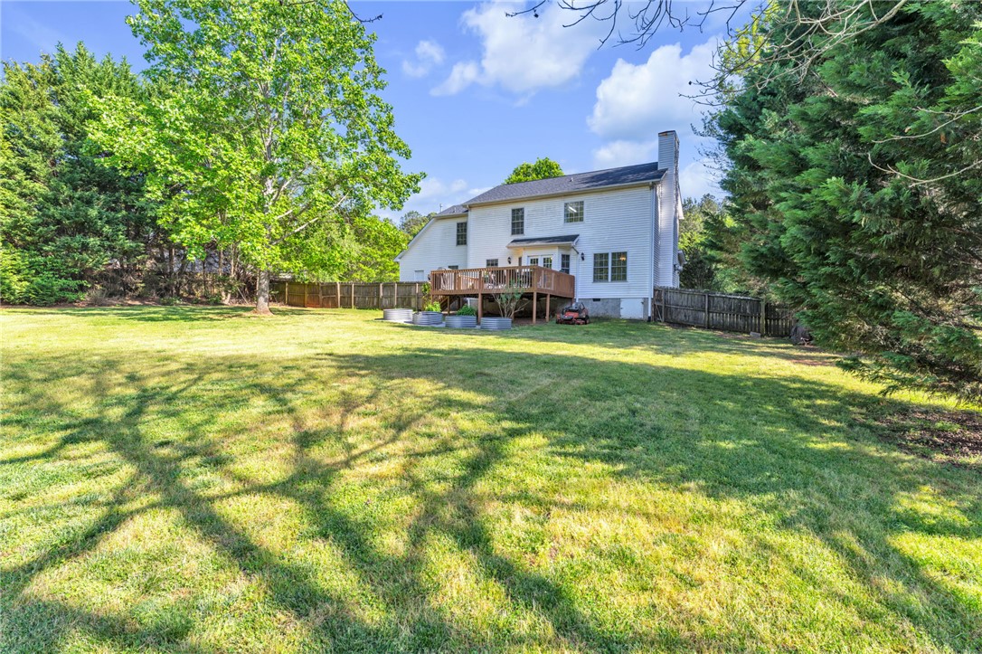 154 Hammond School Road Anderson, SC 29621 - Photo 27 of 33 This spacious yard offers a perfect canvas for outdoor living, featuring a charming deck for entertaining.