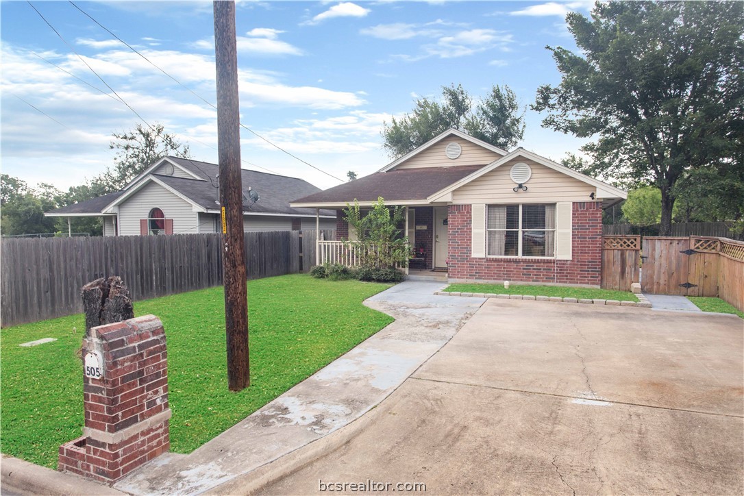 505 Dean Street Bryan, TX 77803 - Photo 1 of 1 a view of a house with a yard and large tree