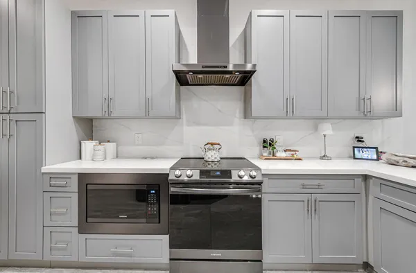 a kitchen with granite countertop a stove and a cabinets