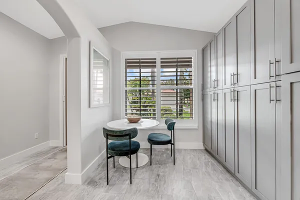 a dining room with furniture and window