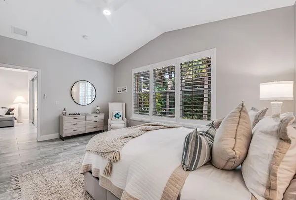 a bedroom with bed and a large mirror