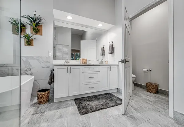 a spacious bathroom with a sink a vanity and a mirror