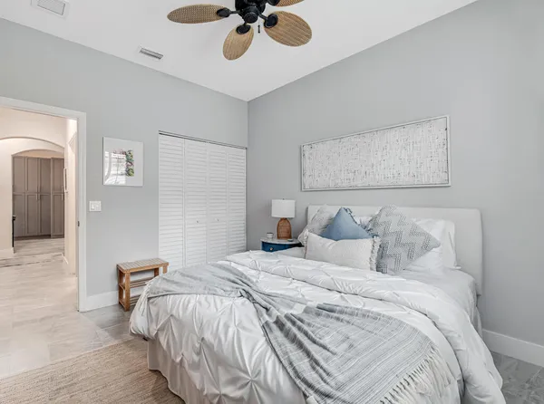 a bedroom with a bed and painting on the wall